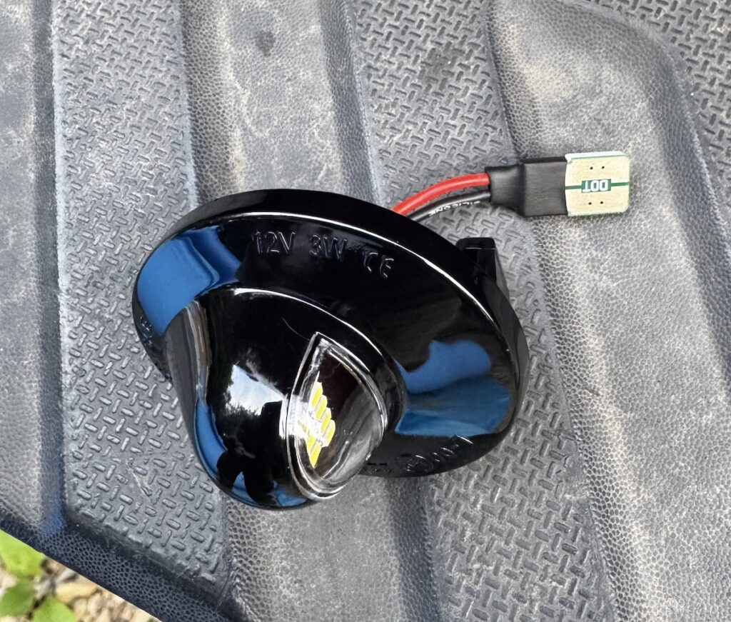 A replacement license plate light for a Ford F250