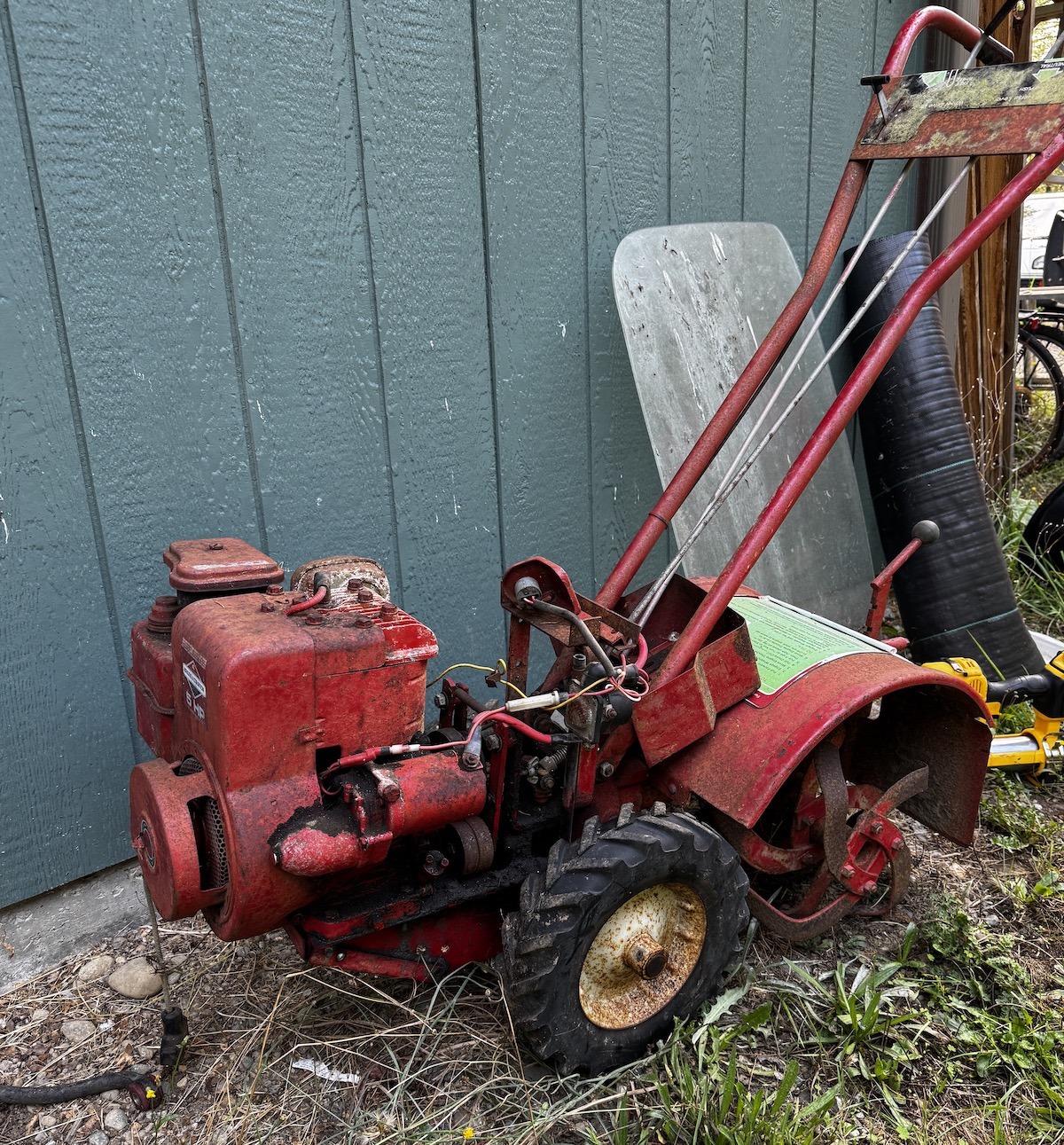 An old red Troy-Bilt rototiller ready for restoration
